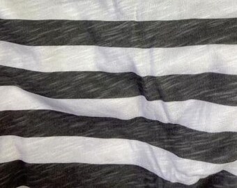 May include: A fabric featuring a horizontal striped pattern with alternating bands of solid white and charcoal gray. The material has a visible slub texture throughout, creating a slightly uneven, heathered appearance across the dark stripes.