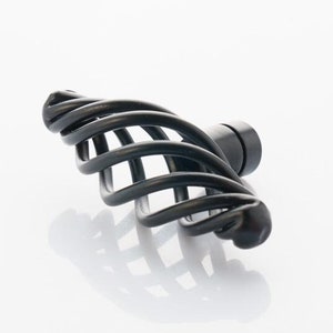 May include: Black metal cabinet knob with a spiral design.