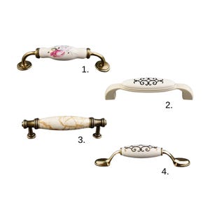 May include: Four decorative cabinet pulls. The pulls feature floral, marble, and patterned ceramic centers with brass-coloured metal hardware. Each pull is a different style, offering options for kitchen or bathroom decor.
