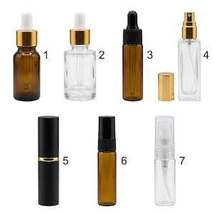 May include: A collection of seven glass cosmetic bottles labeled one through seven. The set includes amber and clear glass containers with various closures, including white and black dropper tops, gold spray nozzles, and black cylindrical caps.
