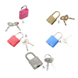 May include: A collection of small padlocks in various colors, including pink, gold, red, and blue, each with a matching set of keys. The locks have a simple, rectangular design and are made of metal. The image is taken from a high angle.