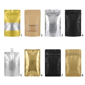 May include: A collection of eight stand-up pouches in various finishes including gold, brown kraft paper, silver, and black. Some feature clear windows, resealable zipper tops, or a top-mounted spout. Each pouch is numbered from one to eight.