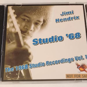 May include: A CD case featuring a photograph of Jimi Hendrix playing a guitar. The text on the case reads "Jimi Hendrix Studio '68 The 1968 Studio Recordings Vol. 1 NOT FOR SALE".
