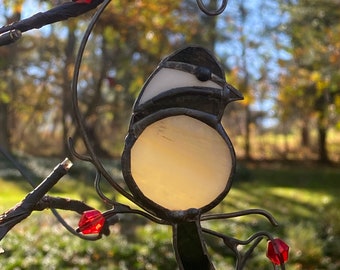 Stained glass resting chickadee