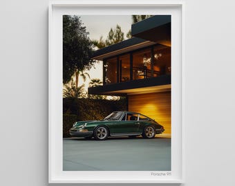 May include: Framed print of a green Porsche 911, a classic car, parked outside a modern house. The image is set during the golden hour, with warm lighting and palm trees in the background. The car has silver wheels. The text "Porsche 911" is at the bottom.