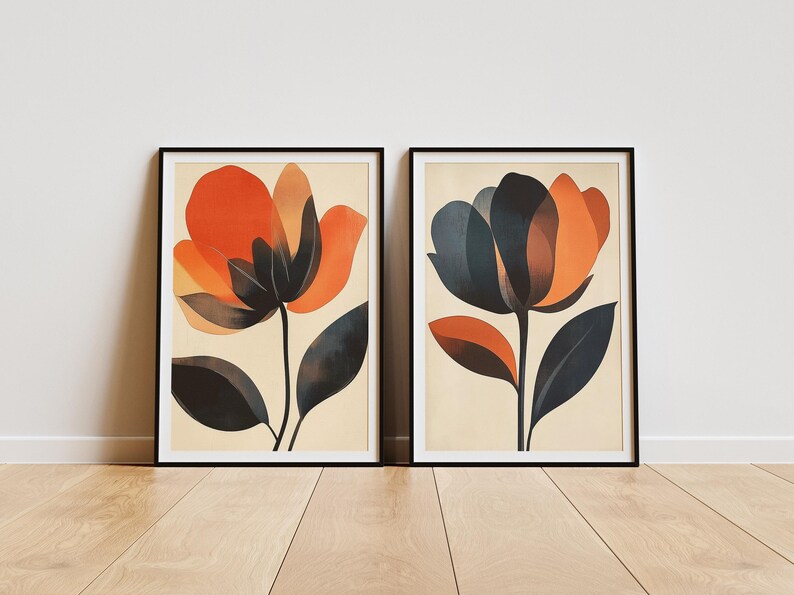 May include: Two framed prints of abstract floral illustrations. The prints feature stylized flowers with orange, red, and black petals. The background of the prints is a light beige.