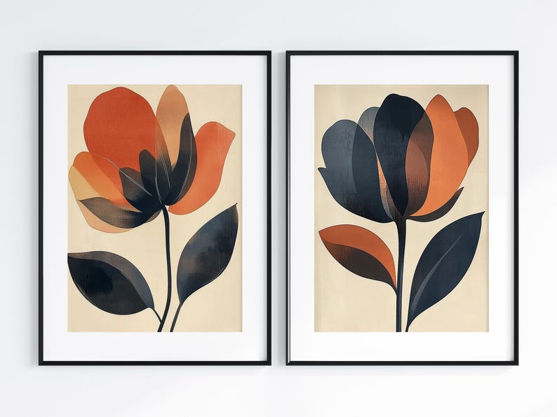 May include: Two framed abstract floral prints with a cream background. The first print features a dark blue and orange flower with dark blue leaves. The second print features a dark orange and red flower with dark blue leaves.