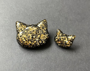 Pin de gato con purpurina dorada y negra