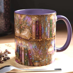 May include: A ceramic mug with a purple interior and handle, featuring a wrap-around illustration of a magical library with shelves of colorful books, blooming flowers, and glowing lights, set against a shimmering, textured, golden-toned background.