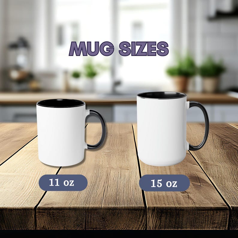 May include: Two white ceramic mugs with black interiors and handles. The left mug is labeled 11 oz and the right mug is labeled 15 oz. The text MUG SIZES appears above the mugs. The mugs are displayed on a wooden surface.