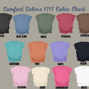 May include: Comfort Colors 1717 colour chart featuring thirteen short-sleeve t-shirts in various colours: pepper, blue jean, moss, crimson, espresso, seafoam, yam, grape, black, blossom, ivory, crunchberry, and white, each labelled below.