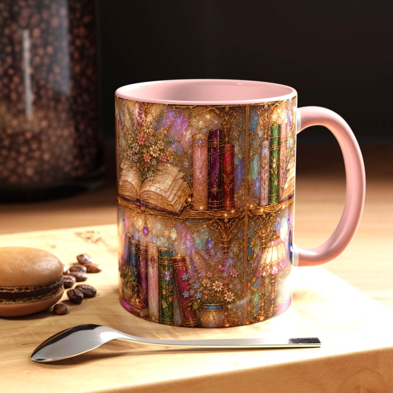 May include: A ceramic mug with a light pink interior and handle, featuring a wrap-around print of a detailed bookshelf filled with colorful books, floral arrangements, and a small lamp, set against a shimmering, textured background of gold and purple.