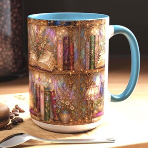 May include: A ceramic mug with a light blue interior and handle, featuring a wrap-around print of a detailed bookshelf. The design includes rows of colorful books, open volumes, floral arrangements, and a decorative lamp, all set against a golden background.