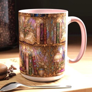 May include: A ceramic mug with a light pink interior and handle, featuring a detailed wrap-around illustration of a multi-level library shelf filled with colorful books, floral arrangements, and a decorative lamp, all set against a golden background.