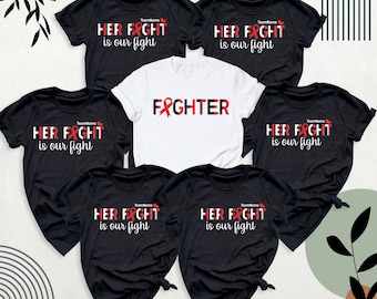 May include: Six black t-shirts with red ribbon designs. The shirts have the text "HER FIGHT is our fight" and one shirt has the text "FIGHTER".