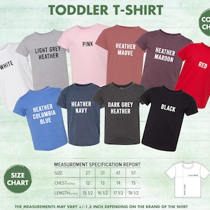 Op de afbeelding: Een kleurenkaart van t-shirts voor peuters in verschillende kleuren, waaronder wit, lichtgrijs melange, roze, heidepaars, heidebordeaux, rood, heidecolumbia blauw, heidemarine, donkergrijs melange en zwart. De kaart bevat ook een maattabel met metingen in inches voor borst en lengte.