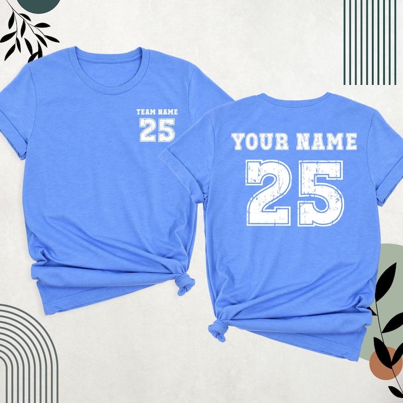 May include: Two light blue t-shirts with a white number 25 printed on the front and back. The front shirt says "Team Name" above the number. The back shirt says "Your Name" above the number.
