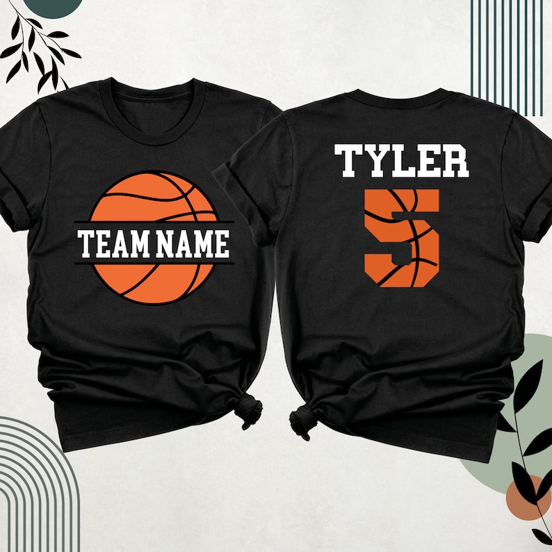 May include: Two black t-shirts with a basketball design. One shirt has the text "TEAM NAME" and a basketball graphic. The other shirt has the text "TYLER" and the number "5" with a basketball graphic.