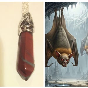 May include: A red and gray gemstone pendant with a silver-colored ornate cap hangs from a silver chain. Next to it is a digital illustration of two bats hanging upside down in a cave with stalactites.