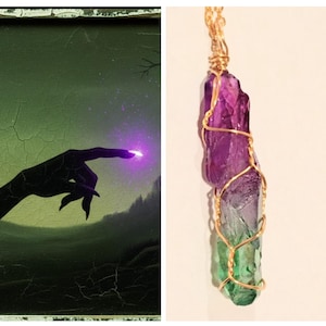 May include: A two-part image. The left side shows a dark silhouette of a hand pointing towards a glowing purple light against a green and gray landscape. The right side displays a pendant with a purple, gray, and green crystal wrapped in gold wire.