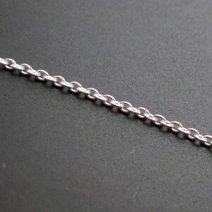 May include: A silver chain necklace with a delicate, linked design.