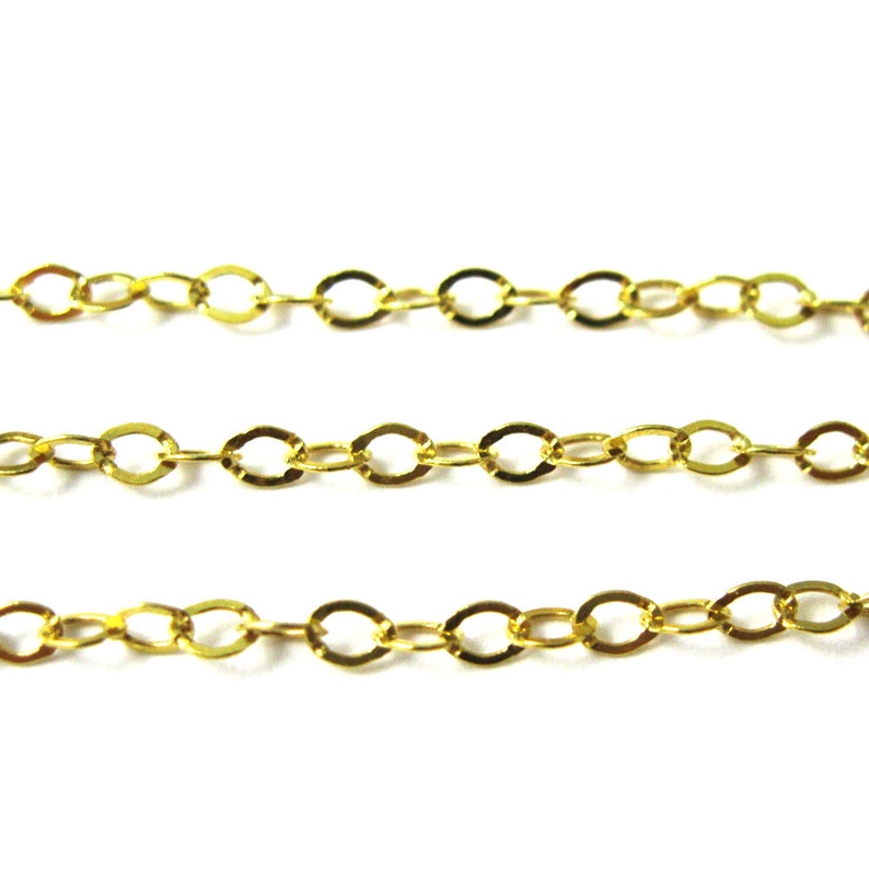 May include: Gold chain with oval links. The chain is made of metal and has a shiny finish.