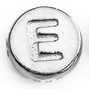 May include: Silver charm bead with the letter E embossed on the front.