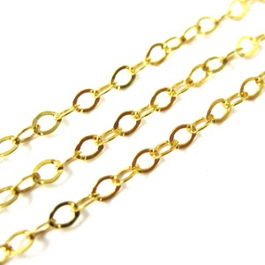 May include: Gold chain with oval links. The chain is made of metal and has a shiny finish.