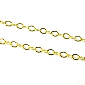 May include: A gold chain necklace with a delicate, oval-shaped link design.