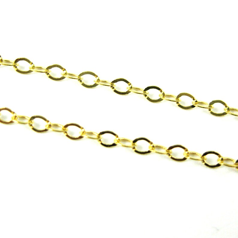 May include: A gold chain necklace with a delicate, oval-shaped link design.