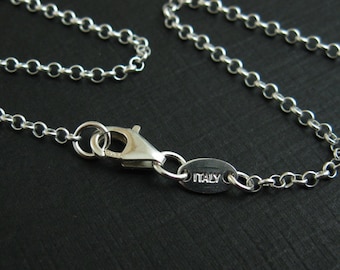 May include: A silver chain necklace with a lobster clasp and a small oval tag that says "ITALY".