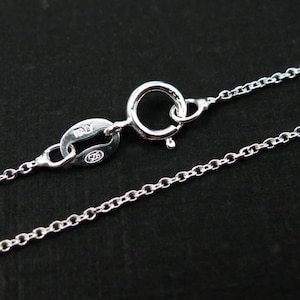 May include: A silver chain necklace with a lobster clasp and a tag that reads "ITALY 925".