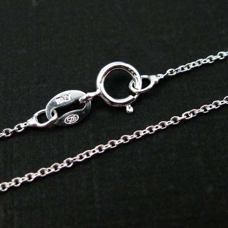May include: A silver chain necklace with a lobster clasp and a tag that reads "ITALY 925".