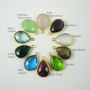 May include: Assortment of 12 teardrop-shaped gemstone pendants with gold-toned bail. The stones are: aqua quartz, green onyx, prehnite chalcedony, pink chalcedony, amethyst, opalite, labradorite, blue quartz, ruby dyed, peridot.