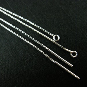 May include: Three silver chain earring extenders with jump rings at the end. The extenders are approximately 5 cm long.
