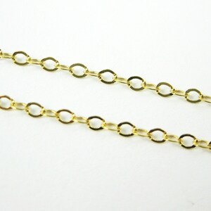 May include: A gold chain necklace with a delicate, oval-shaped link pattern.