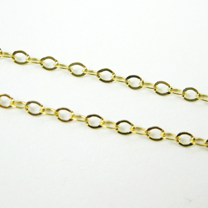 May include: A gold chain necklace with a delicate, oval-shaped link pattern.