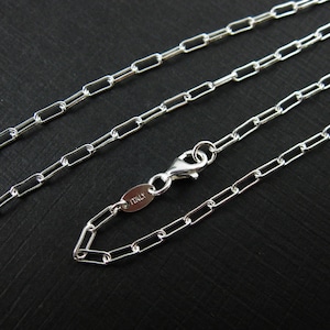 May include: A silver chain necklace with a lobster clasp and a tag that says "ITALY".