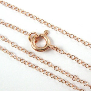 May include: A rose gold chain necklace with a lobster clasp closure.
