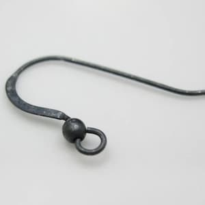 May include: A black metal earring hook with a small ball at the end and a loop for attaching jewellery.
