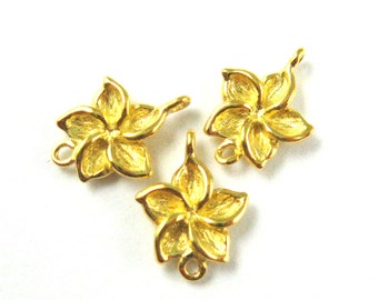 May include: Three gold-tone metal flower charms with a five-petal design. Each charm has two jump rings for attaching to jewelry.