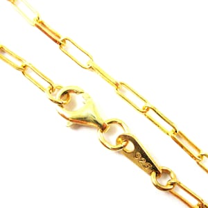 May include: A gold chain necklace with a lobster clasp closure. The clasp is marked with "925", indicating it is made of sterling silver.