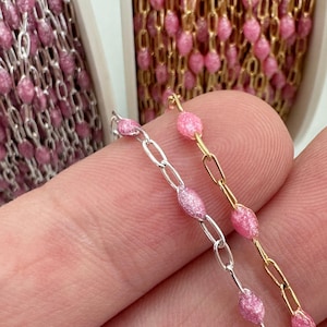 以下が含まれることがあります： 楕円形のリンクを持つピンクのチェーンが2本。1本のチェーンはシルバー、もう1本のチェーンはゴールドです。