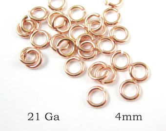 May include: A pile of 21 gold-toned jump rings, each measuring 4 mm in diameter.