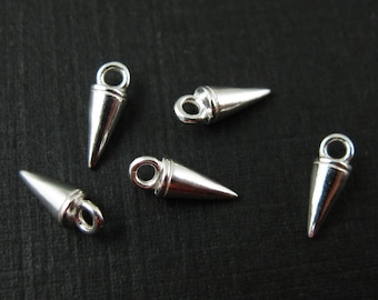 May include: Five silver-colored cone-shaped charms with a loop at the top for attaching to jewelry. The charms have a pointed end and a smooth, polished surface. These charms are ideal for DIY jewelry making.