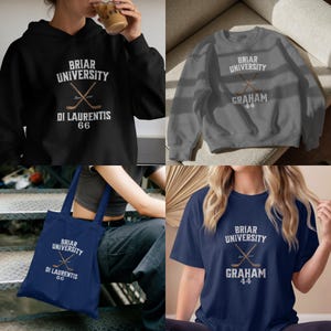 May include: A collection of apparel featuring the text "Briar University" with crossed hockey sticks. Items include a black hoodie, gray sweatshirt, navy tote bag, and navy t-shirt. The hoodie and tote bag also display "Di Laurentis 66", while the sweatshirt and t-shirt show "Graham 44".