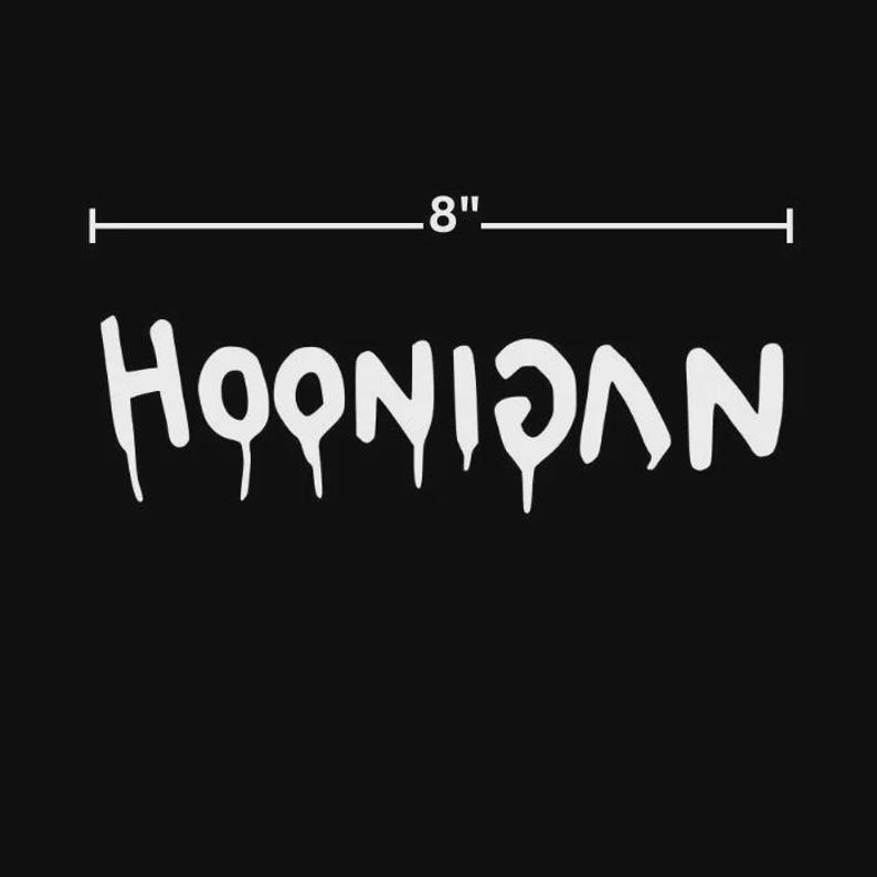 May include: White "HOONIGAN" text with dripping effect, 8 inches wide, on a black background. The text is a stylized font, suitable for decals or stickers.