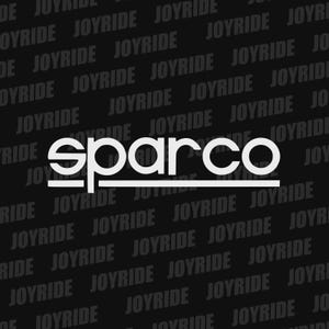May include: White "sparco" logo with a horizontal line underneath, set against a black background. The background is covered with the word "JOYRIDE" in a diagonal pattern.
