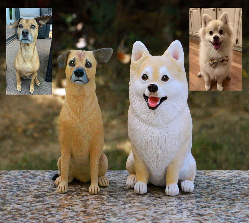 May include: Three ceramic dog figurines, two sitting and one standing. The figurines are realistic and detailed, with brown, white, and cream fur. The standing figurine is wearing a small bow tie.
