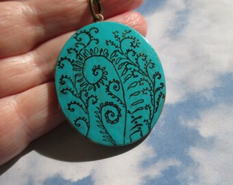 Fiddlehead Fern Art on verdigris oval vintage locket comes with brass chain
